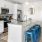 Model kitchen at our senior living communities in Myrtle Beach, SC, featuring wood grain flooring and a kitchen island.