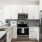 Model kitchen at The Grove at Coastal Grand apartments in Myrtle Beach, SC, featuring stainless steel appliances.