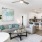 Model living room at our 55+ retirement community in Myrtle Beach, featuring wood grain flooring and a grey couch.